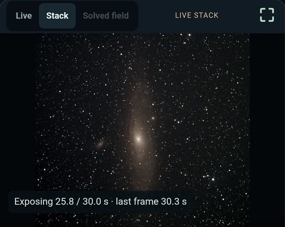 Phone screenshot of Astronomical live stacking the Andromeda Galaxy: the Stack tab, a starry frame with the galaxy, and the line Exposing 25.8 of 30.0 s